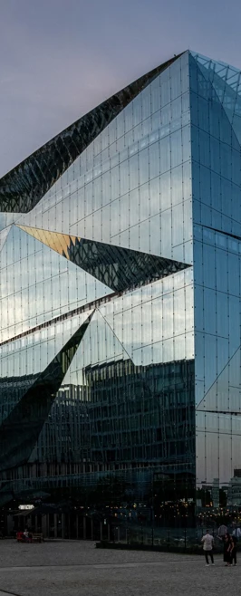 Reflective glass skyscraper in Berlin with dynamic angles and mirrored surfaces, capturing the surrounding cityscape. Reflective glass skyscraper in Berlin with dynamic angles and mirrored surfaces, capturing the surrounding cityscape.